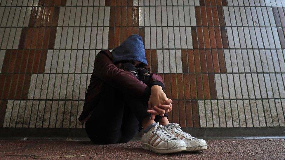 A teenage girl sitting down