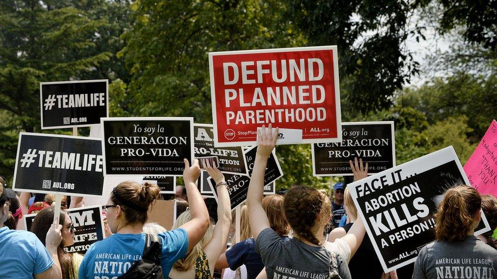 Anti-abortion activists hold a rally opposing federal funding for Planned Parenthood in front of the U.S. Capitol