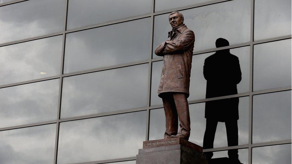 Sir Alex Ferguson's statue stands outside the famous Old Trafford football ground