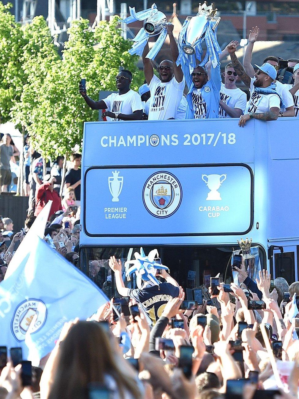 Manchester City's midfielder Fabian Delph holds up the Premier League trophy