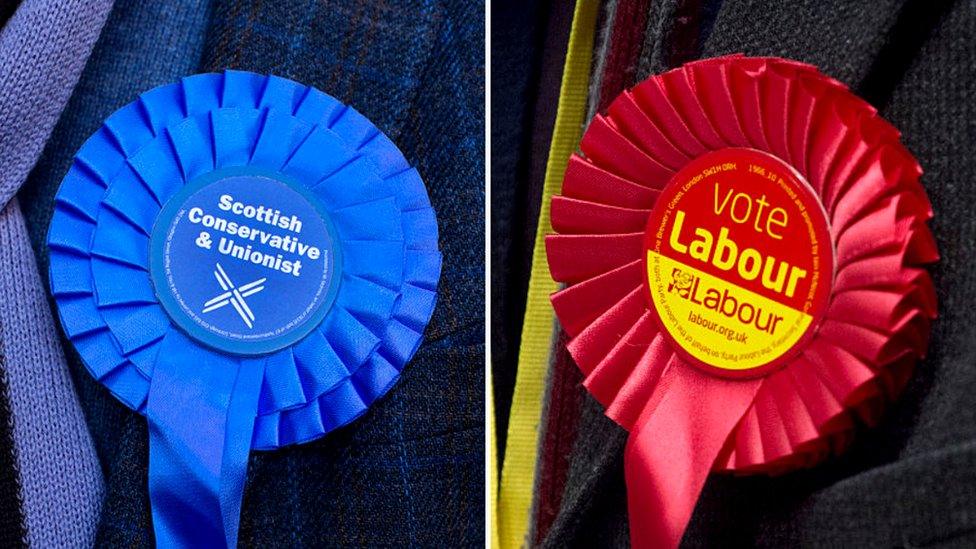 Conservative and Labour rosettes