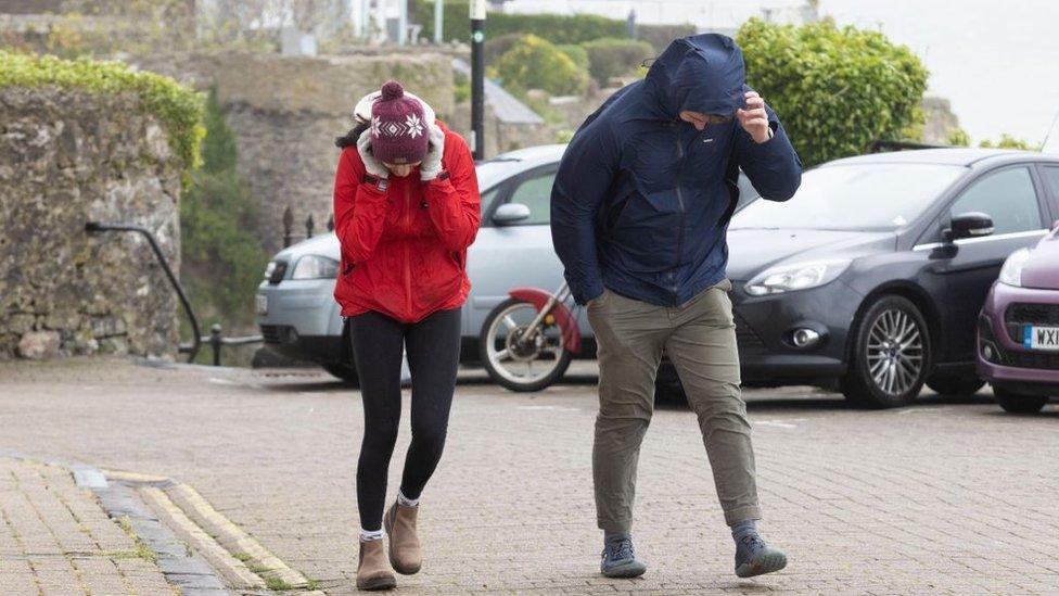 People in strong winds in Tenby