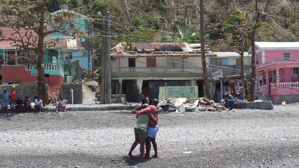 Glen Hector is greeted by his mother and sister upon arriving home in Scott's Head loaded with supplies from Antigua