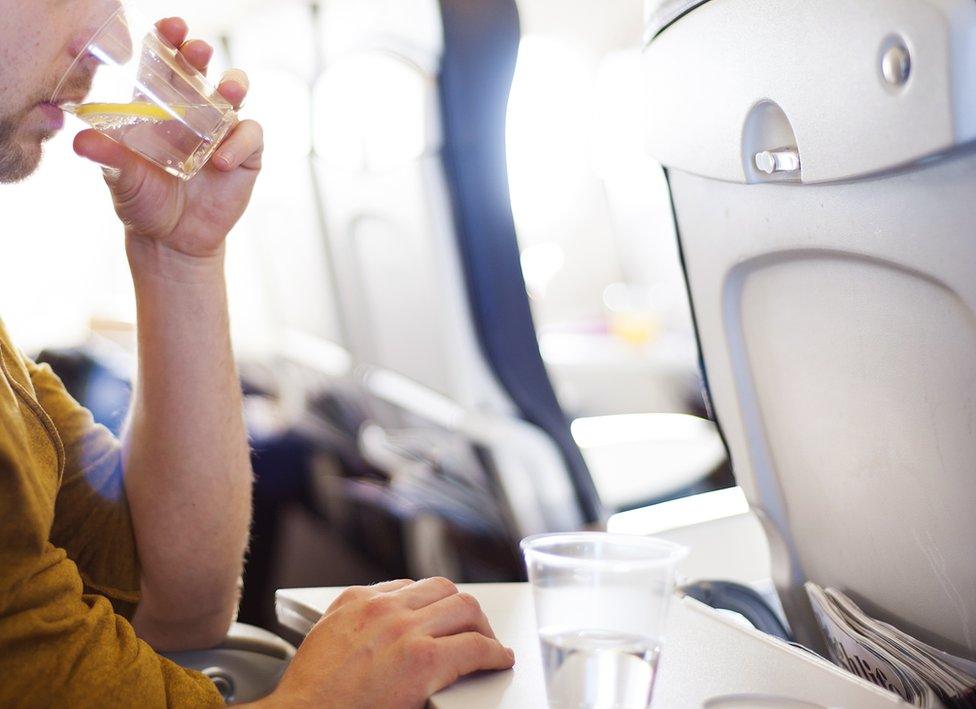 Man drinks on aircraft