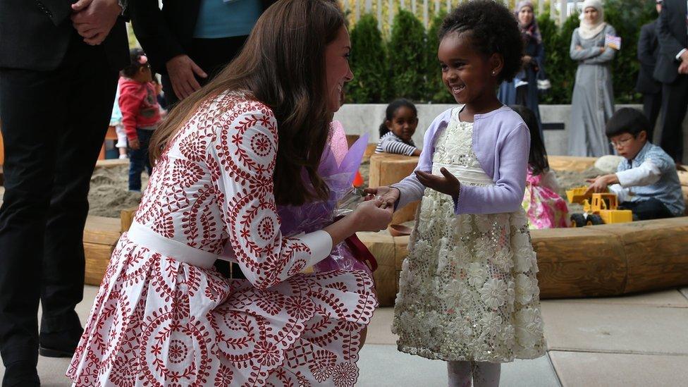 The Duchess of Cambridge receives flowers at the Immigrant Services Society