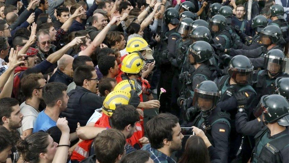 Spanish police stand outside a polling centre in Barcelona, Catalonia