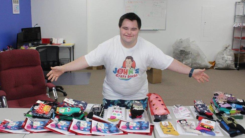 John preparing socks for delivery at his office