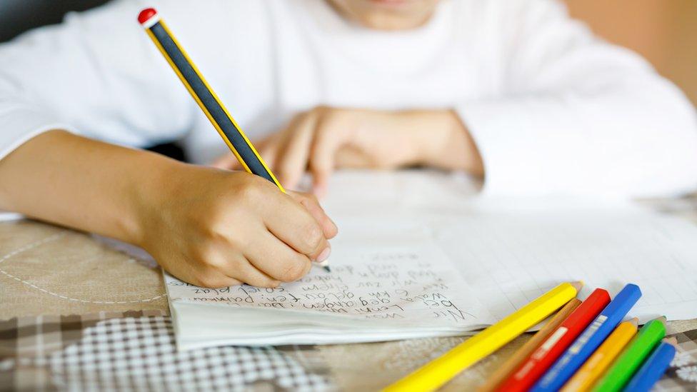 Child writing in notebook