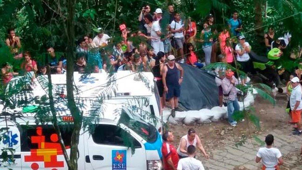 Picture by the National Disaster Risk Management Unit shows ambulances and onlookers near the site of the bridge collapse