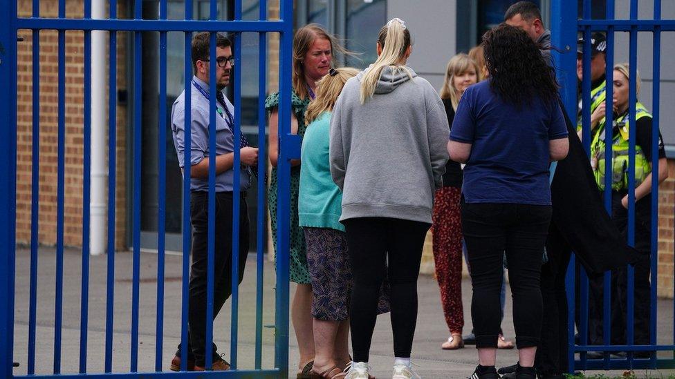 Staff and police at school gates