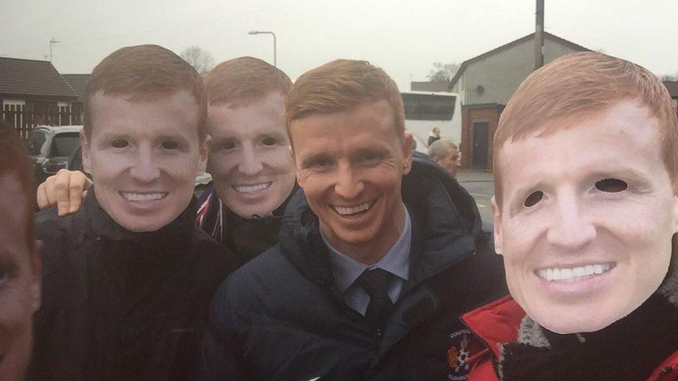 Footballer Scott Boyd and County fans wearing masks of his face