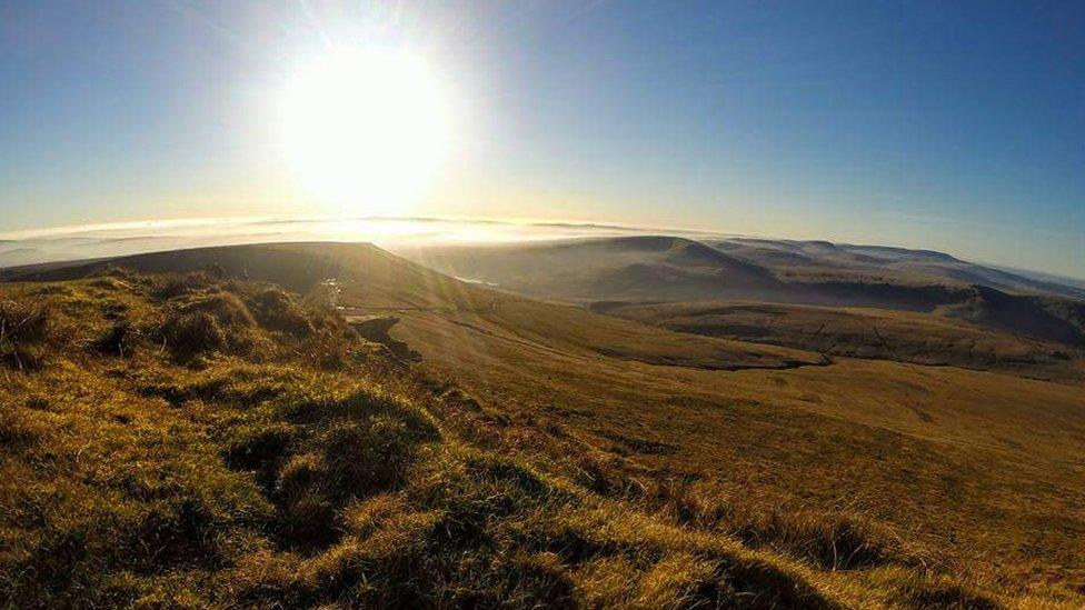 The sun shining over Pen Y Fan, taken by Nicole Harris