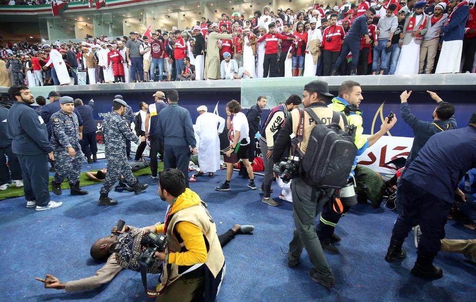 Fans are wounded after a glass barrier collapsed at the end of the Gulf Cup of Nations 2017 final football match between Oman and the UAE at the Sheikh Jaber al-Ahmad Stadium in Kuwait City, 5 January 2018