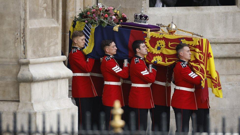 The coffin of Queen Elizabeth II carried by pallbearers