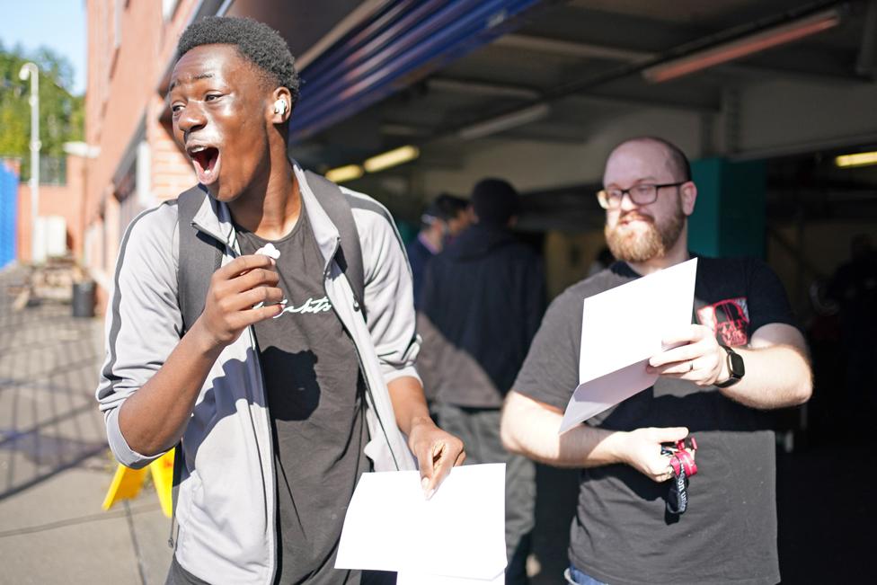 A student celebrates after opening his GCSE results