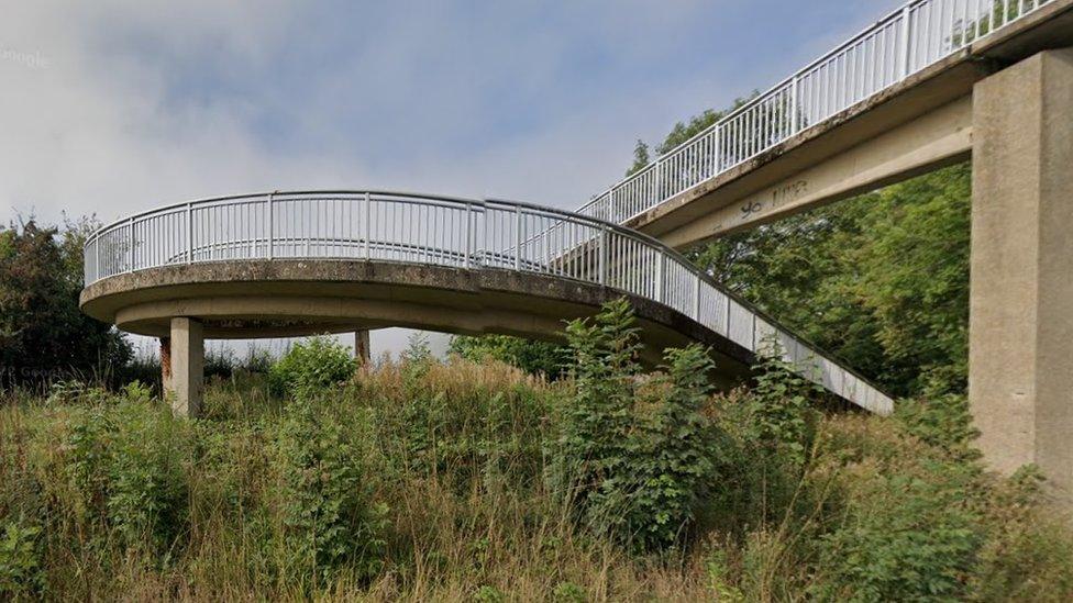 Concrete bridge showing spiral steps and ramp from ground level to the overbridge