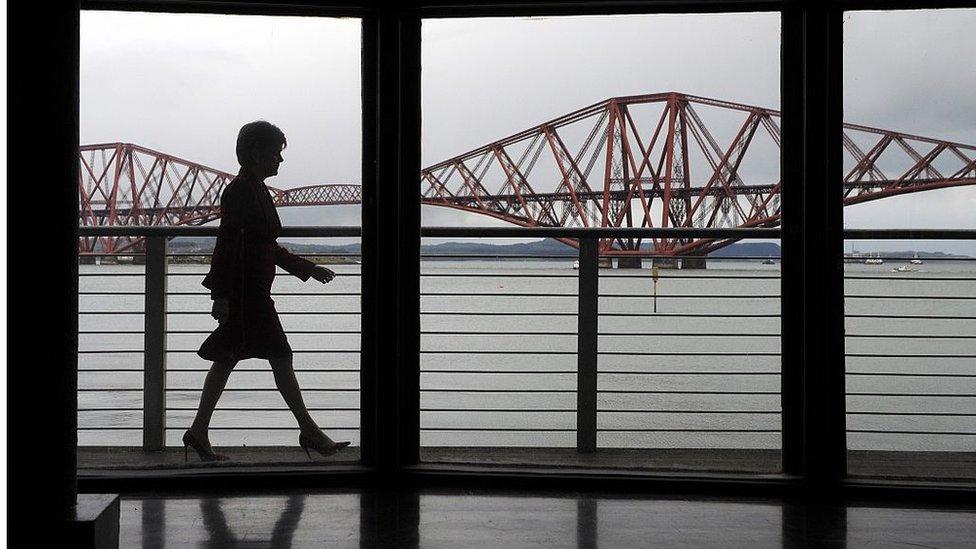 Nicola Sturgeon walks in front of the Forth Bridge