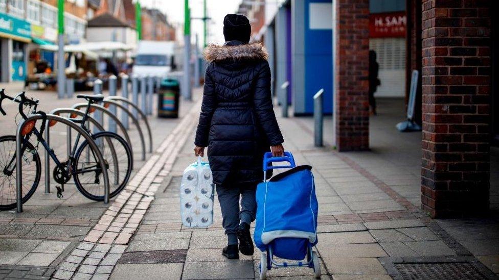 Shopper with toilet rolls