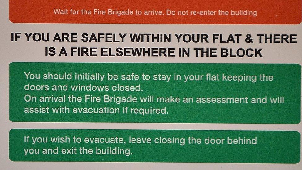 A fire action sign from a block near Grenfell Tower