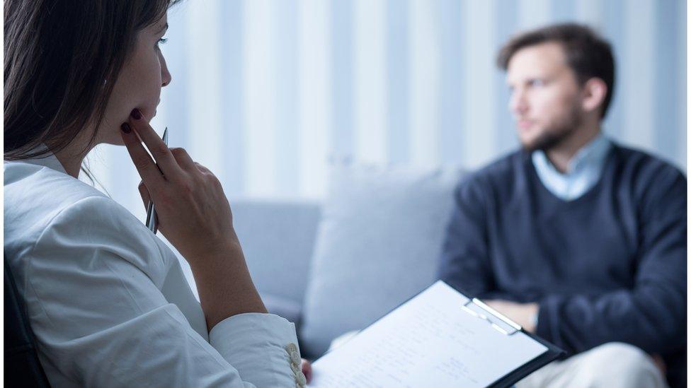 Psychiatrist talks to a patient - posed photo