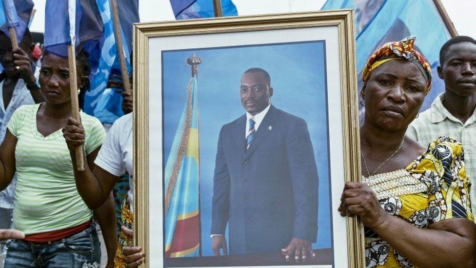 Civilians gather as they listen to the Democratic Republic of Congo"s President Joseph Kabila addressing the nation outside Palais du Peuple in the capital Kinshasa