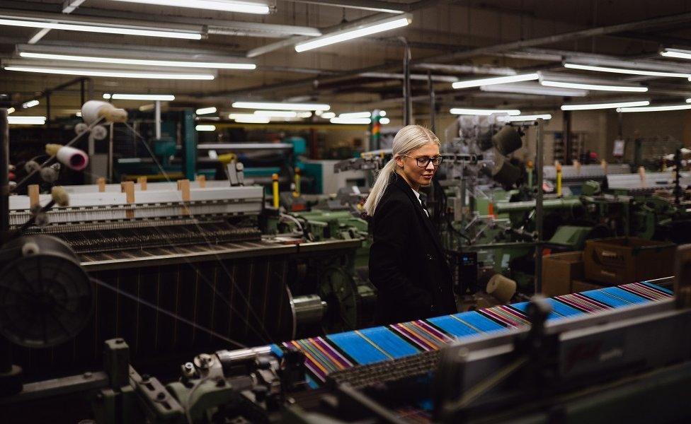 Siobhan Mackenzie looking at looms