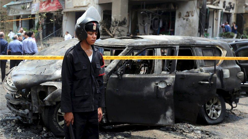 Policemen investigate the site of a car bomb attack on the convoy of Egyptian public prosecutor Hisham Barakat in Cairo, Egypt, 29 June 2015.