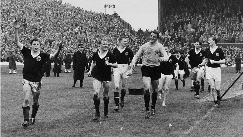 Willie Henderson (far left) leads the Scottish team on a lap of honour at Hampden Park, Glasgow, after their 1-0 victory over England to win the British Championships, 11th April 1964.