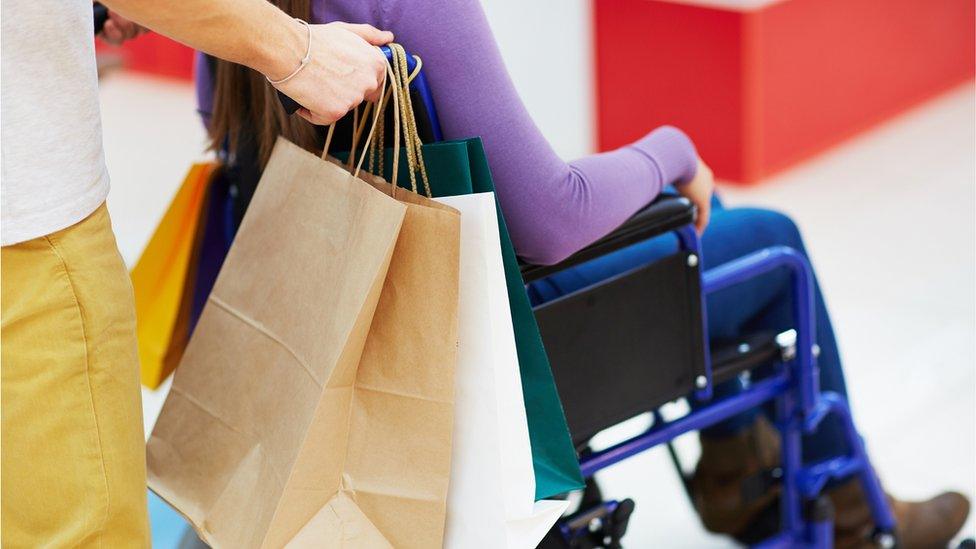 Shopping bags and person in wheelchair