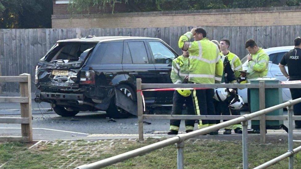 Damaged car after it was rammed by a military truck