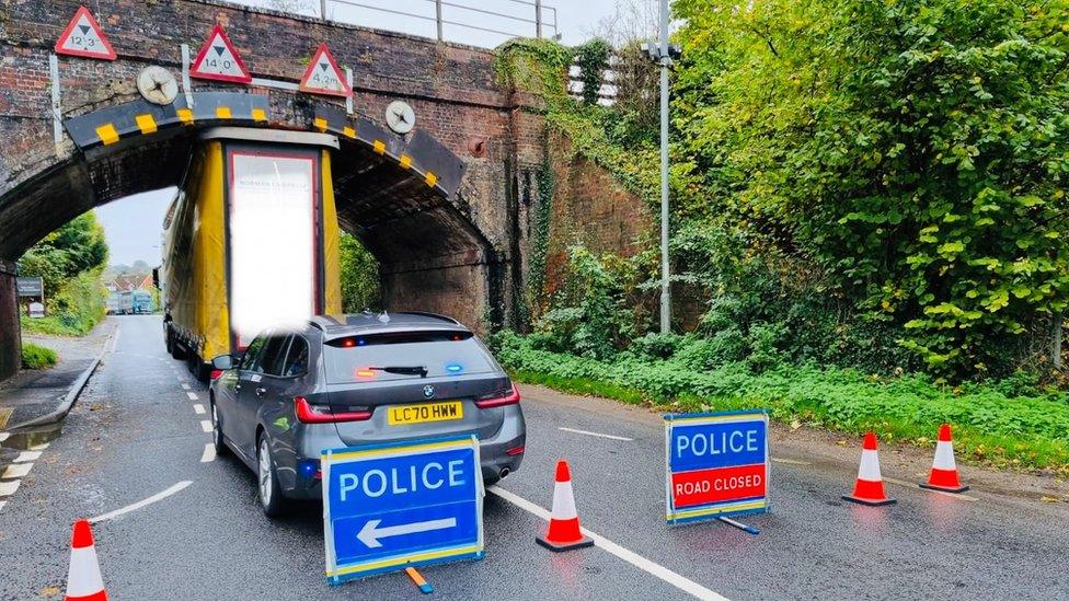 A lorry trapped beneath a railway bridge