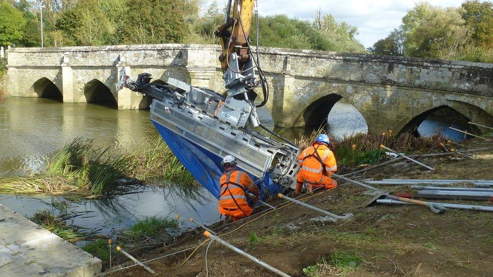 Nails being installed in river bank