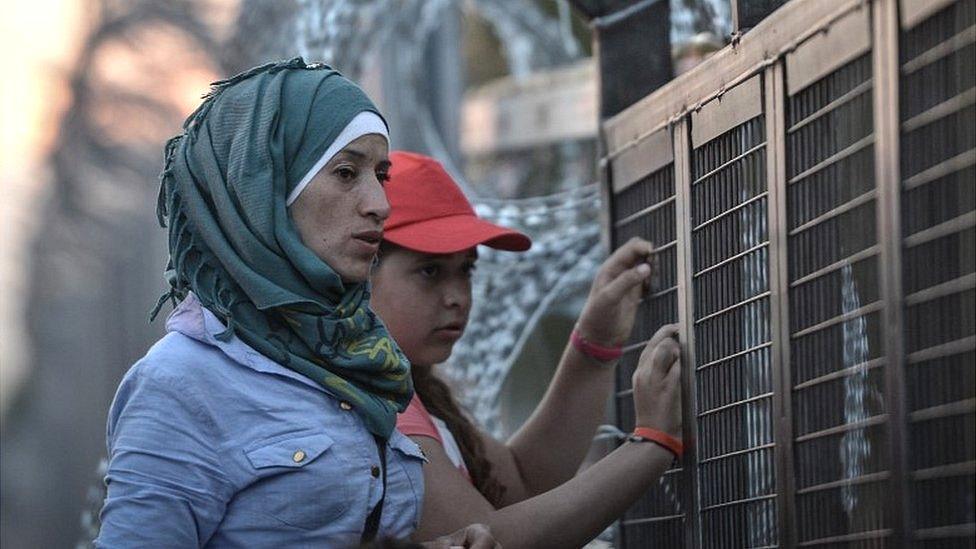 Migrants at Hungary border fence, 2015 file pic