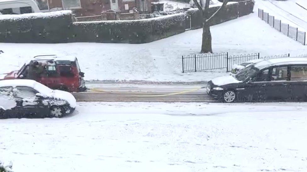 Hearse being towed up hill