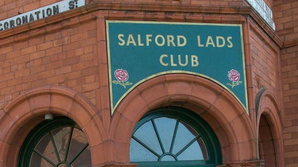 Postman walks past Salford Lads Club