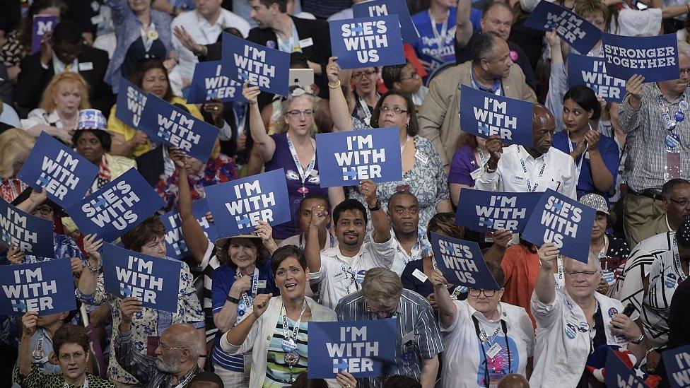 Delegates hold up signs in support of Hillary Clinton on Day 1 of the Democratic National Convention