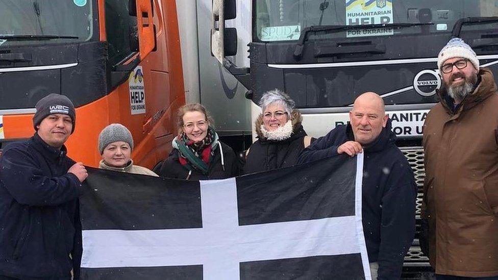 Truck drivers holding the Cornish flag