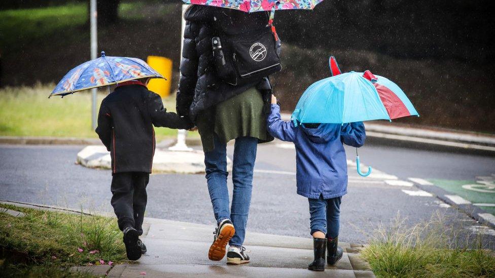 Mother and two kids walk to school in the suburb of Bondi on 25 May 2020 in Sydney, Australia