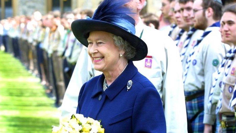 The Queen, with Chief Scout George Purdy, reviews Queens Scouts at Windsor Castle in 2002