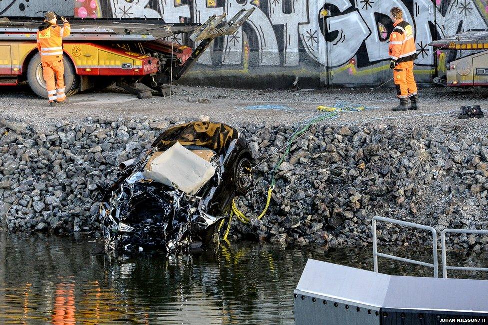 The band's car being pulled out of a canal