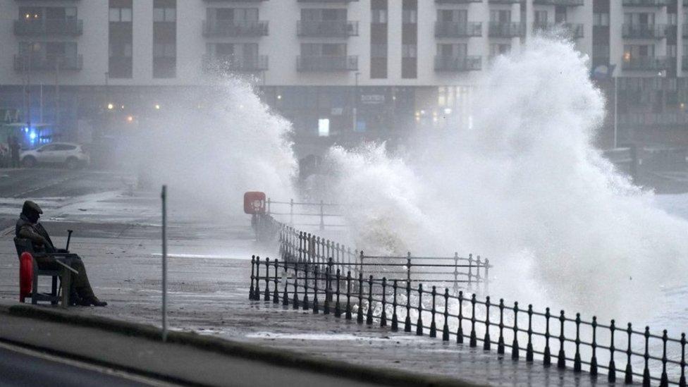 Waves crash into the Freddie Gilroy sculpture in Scarborough