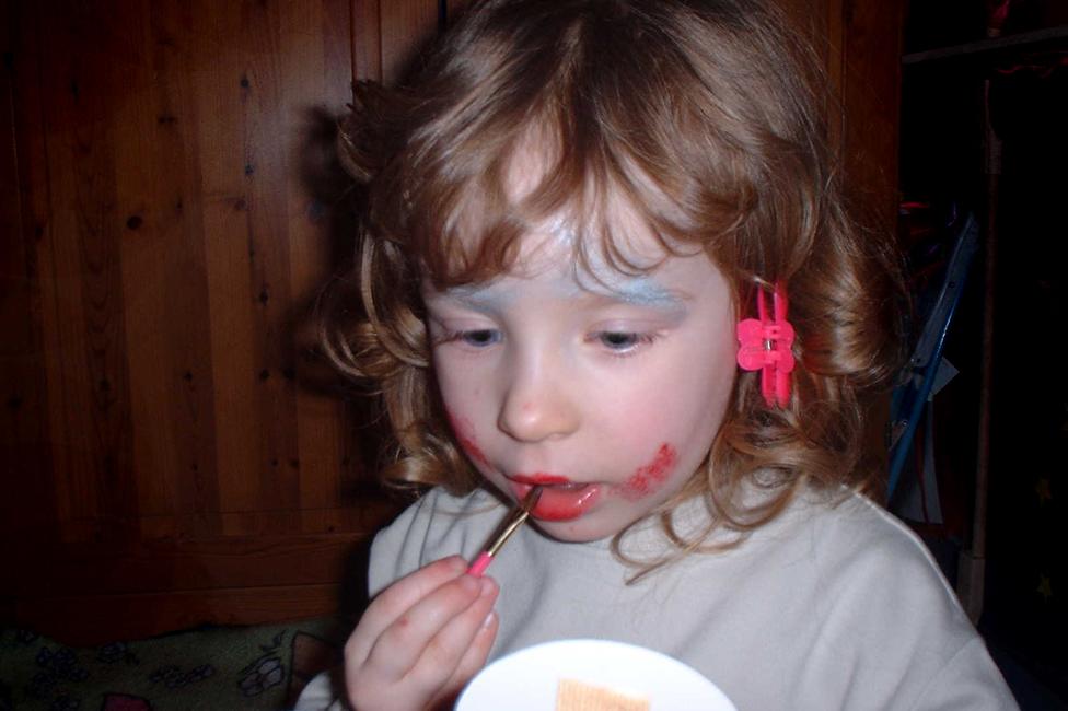 Red experimenting with make-up as a toddler