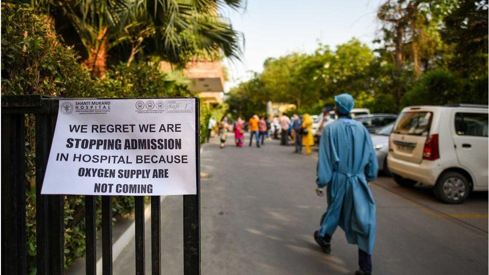 A public notice hangs outside a Delhi hospital notifying shortage of oxygen beds