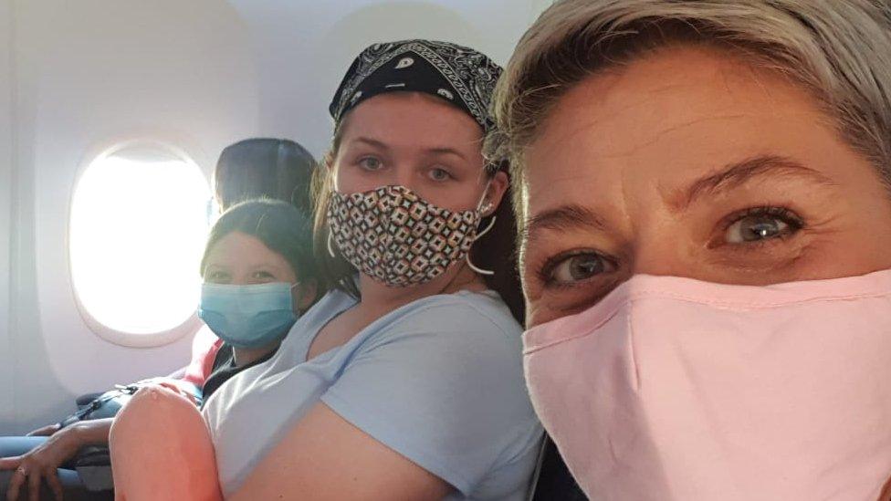 people wearing masks on flight