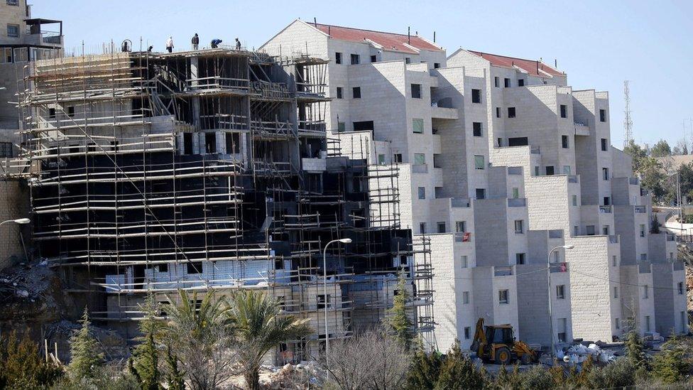 Builders work on new settler homes at Kiryat Arba, near the West Bank city of Hebron (7 February 2017)