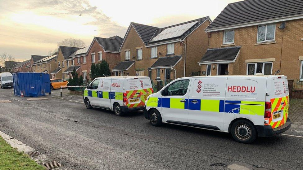 Police vans outside the house in Caerau