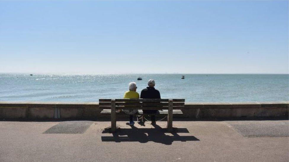 A man and woman sitting on a bench