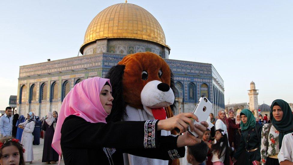 A woman takes a selfie after prayers at a mosque in Jerusalem.