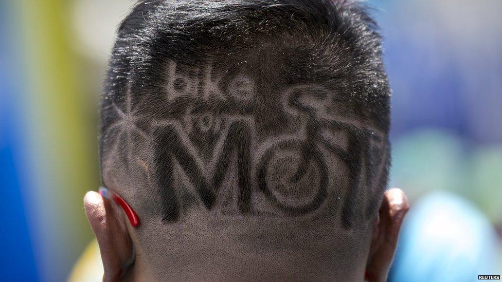 A participant with the name of the event shaved into his hair takes part in the "Bike for Mom" in Bangkok, Thailand, on Sunday