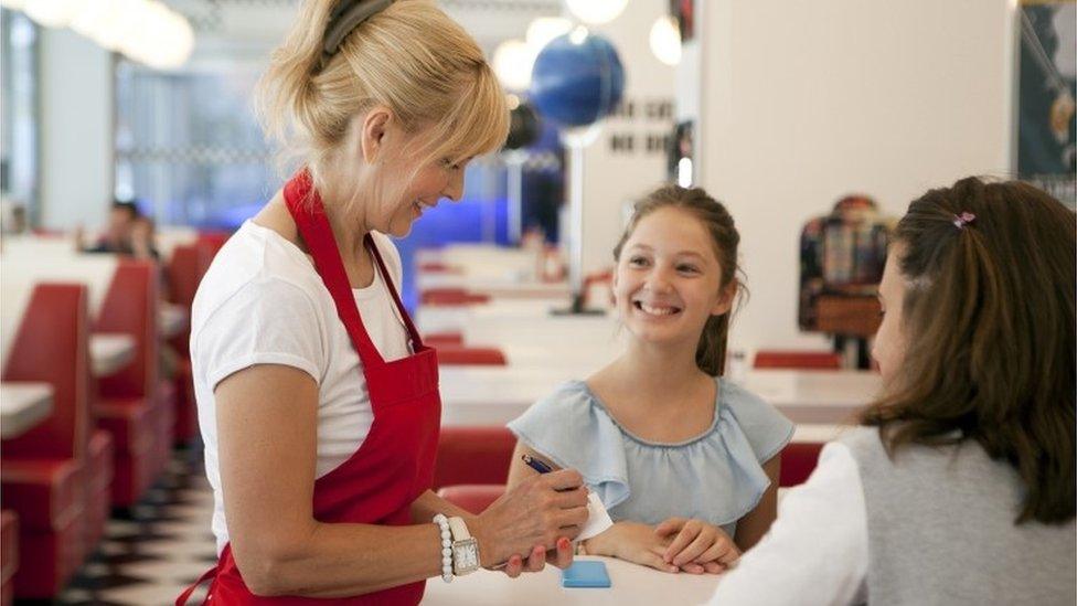 Waitress takes order from friends at lunch time